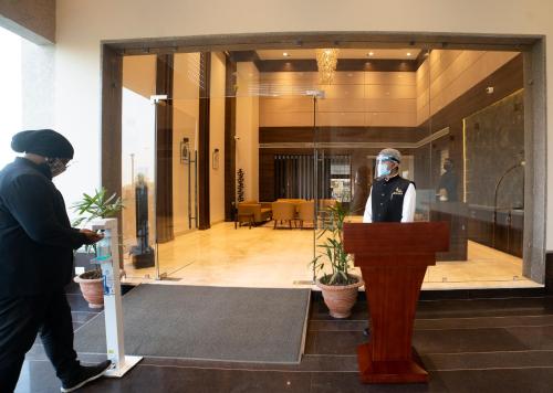 a man wearing a mask standing at a podium at HOTEL RAJHANS ABHINANDAN in Bhopal