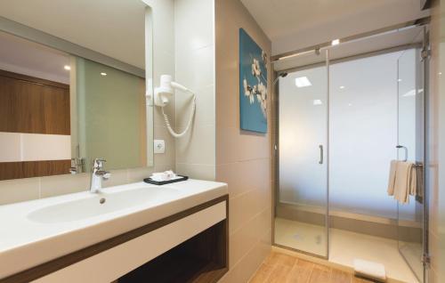 a bathroom with a sink and a shower at Hotel Riu Bravo - 0'0 All Inclusive in Playa de Palma