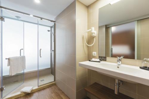a bathroom with a sink and a shower at Hotel Riu Bravo - 0'0 All Inclusive in Playa de Palma