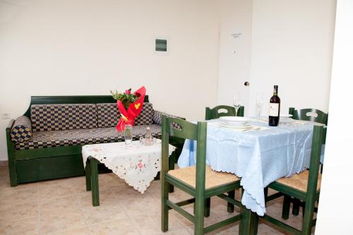 a dining room with a table and a couch at Meandros in Almirida