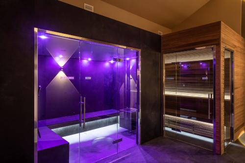 a purple bathroom with a shower with purple lights at Castel Hörtenberg in Bolzano