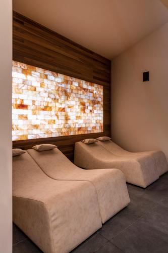 two beds in a room with a brick wall at Castel Hörtenberg in Bolzano