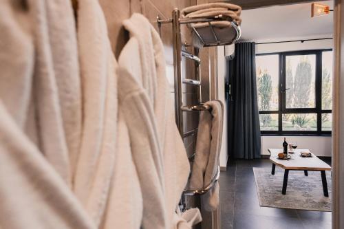 a bathroom with white towels hanging on a wall at Sofia Hotel in Rivne