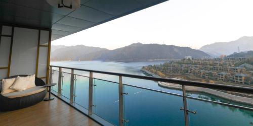 a balcony with a view of a river at Crowne Plaza Hangzhou Thousand Island Lake by IHG in Thousand Island Lake