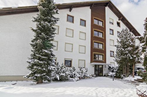 a large white building with snow in front of it at Appartement Förster in Oy-Mittelberg