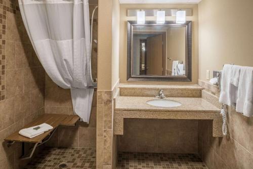 a bathroom with a sink and a mirror at AmericInn by Wyndham Valley City Conference Center in Valley City