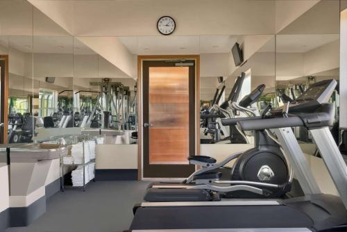 a gym with a treadmill and a clock on the wall at Baymont by Wyndham Bremerton WA in Bremerton