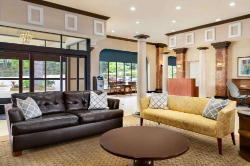 a living room with a couch and a table at Baymont by Wyndham Bremerton WA in Bremerton