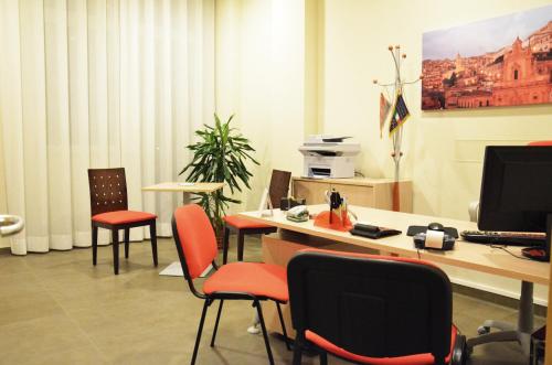 an office with chairs and a desk with a computer at Hotel Torre Del Sud in Modica