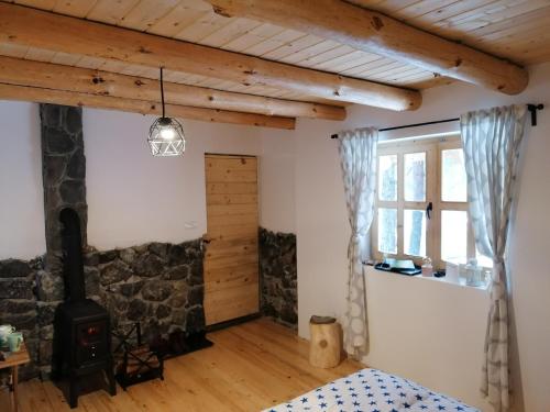 a bedroom with a wood stove in a room at Garac Zlatibor Vikendica in Zlatibor