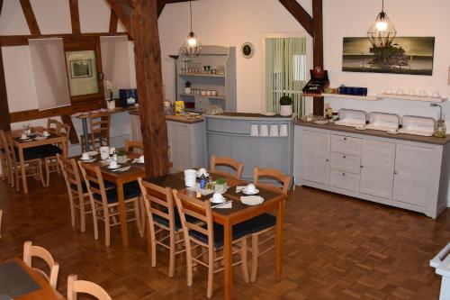 a kitchen and dining room with tables and chairs at Pension Maintal Eltmann in Eltmann