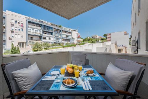 a table on a balcony with food on it at Apartment Blue Lagoon in Split