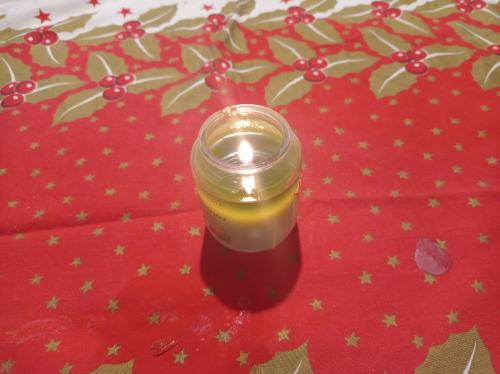 a candle in a glass jar sitting on a table at La Casa di Tara B&B Armonia e Natura in Recanati