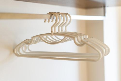 a pair of wooden hangers in a closet at Aquatel Vung Tau in Vung Tau