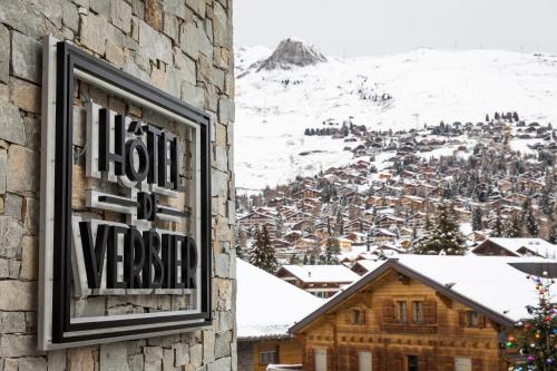 a sign on the side of a building with a mountain at Hôtel de Verbier SUP in Verbier