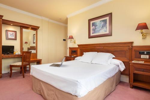 Un pat sau paturi într-o cameră la Hospedium Hotel Blu Loiu