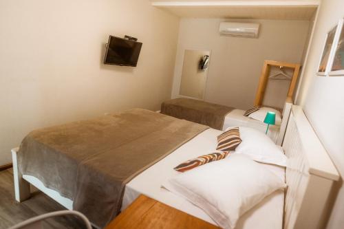 Una cama o camas en una habitación de Pousada Seu Dodó