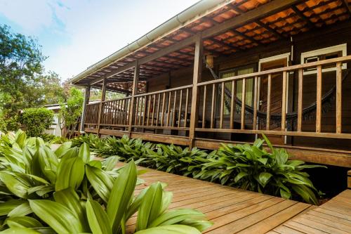 a house with a wooden deck and some plants at Pousada Seu Dodó in Fernando de Noronha