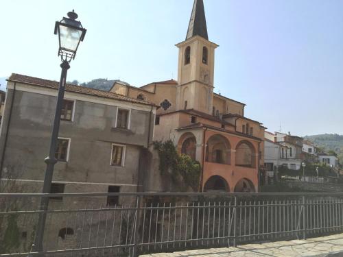 a church with a street light in front of a building at La Casa del Cavaliere in Borgomaro