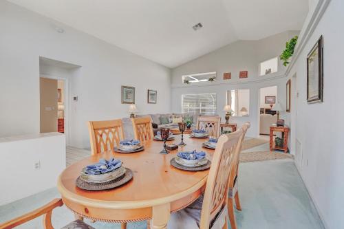 a kitchen and dining room with a wooden table and chairs at Quiet Home With Private Pool- Near Disney in Kissimmee