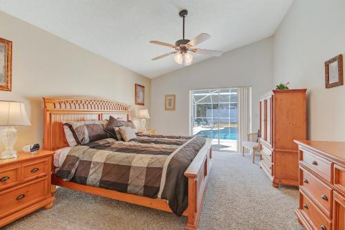a bedroom with a bed and a ceiling fan at Quiet Home With Private Pool- Near Disney in Kissimmee