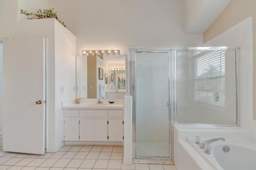 a white bathroom with a shower and a sink at Quiet Home With Private Pool- Near Disney in Kissimmee