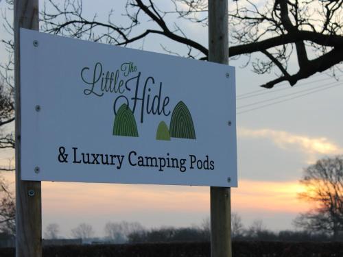 a sign for the little tribe and luxury camping pods at The Little Hide - Grown Up Glamping in Wigginton