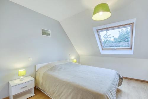 Habitación blanca con cama y ventana en Iroise, en Lamballe