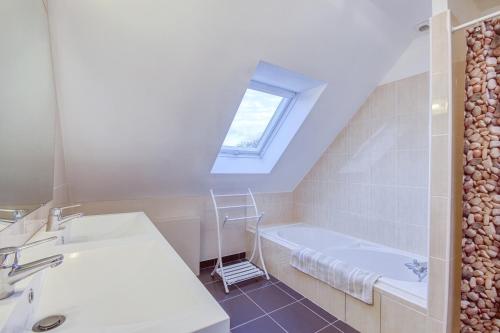 a bathroom with a sink and a bath tub at Iroise in Lamballe