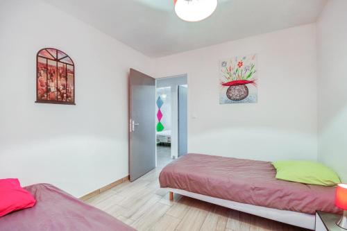 Ένα ή περισσότερα κρεβάτια σε δωμάτιο στο La Coralienne