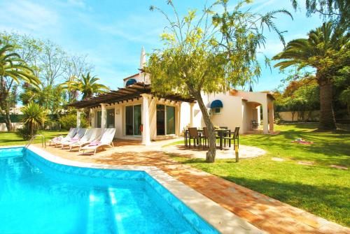a villa with a swimming pool and a house at Villa Bogota by Algarve Vacation in Albufeira