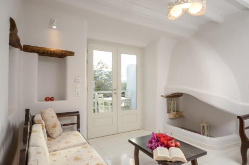 a living room with a couch and a table at Naxian Queen Luxury Villas & Suites in Agia Anna Naxos