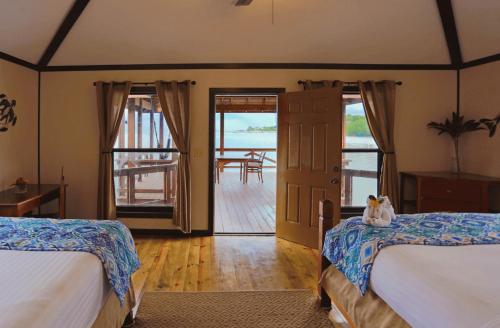 a bedroom with two beds and a door to a porch at Anthony's Key Resort in Sandy Bay