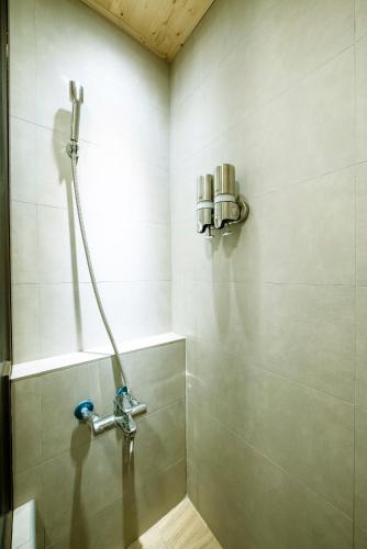 a shower in a bathroom with a shower head at 唯識禪居-訂房後需聯繫轉帳 in Tainan