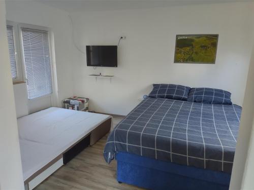 Postel nebo postele na pokoji v ubytování Apartman Borna