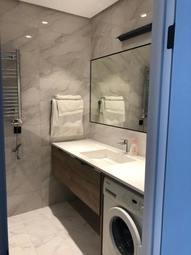 a bathroom with a sink and a washing machine at SEA BREEZE LIGHTHOUSE in Baku