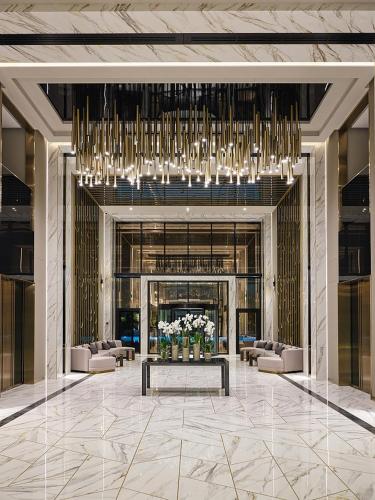a lobby with couches and a large chandelier at SEA BREEZE LIGHTHOUSE in Baku