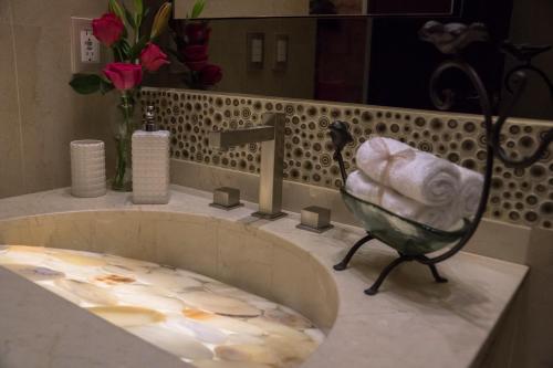 a sink in a bathroom with a towel in it at Hotel De La Soledad in Morelia