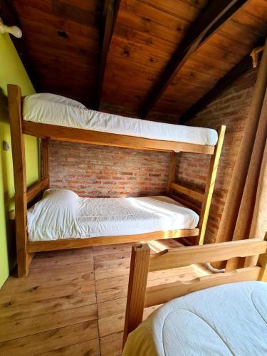 a bedroom with two bunk beds in a attic at Complejo Vidas del Mar in Punta Del Diablo