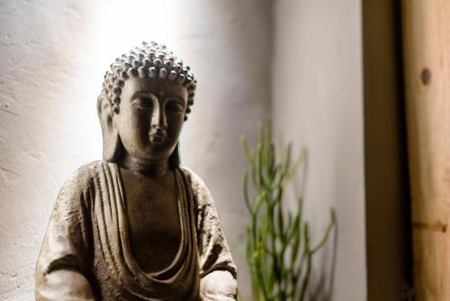 a statue of a buddha in a room at 唯識禪居-訂房後需聯繫轉帳 in Tainan