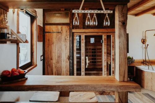 a kitchen with wooden walls and a table with apples on it at Treehouse Drevesna hiška Štrkovo gnezdo Ranč Jureš in Ljutomer