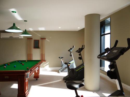 a gym with a pool table and exercise equipment at Diamond Hotel in Rio de Janeiro
