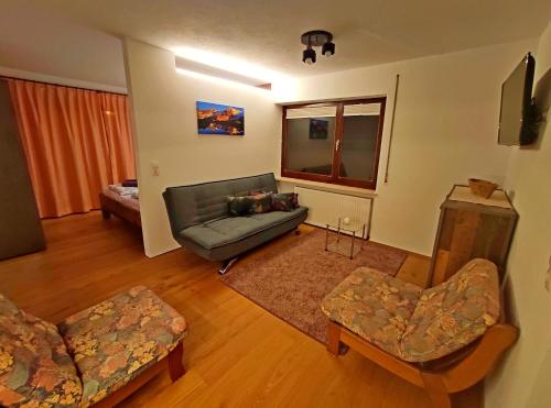 a living room with a couch and a chair at Aira Apart in Nauders