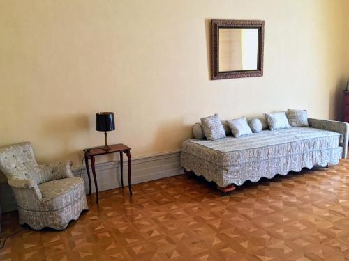 a living room with a couch and a chair at Károlyi Kastély Hotel & Restaurant in Fehérvárcsurgó