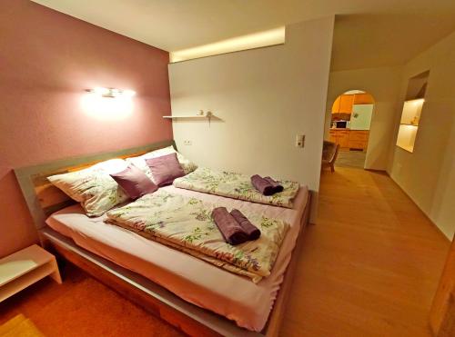a bedroom with a bed with two pillows on it at Aira Apart in Nauders