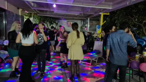 a group of people dancing at a party at Villa George - Family Holidays in Nea Makri