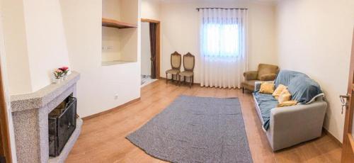 a living room with a couch and a fireplace at Casa da Viela in Arouca