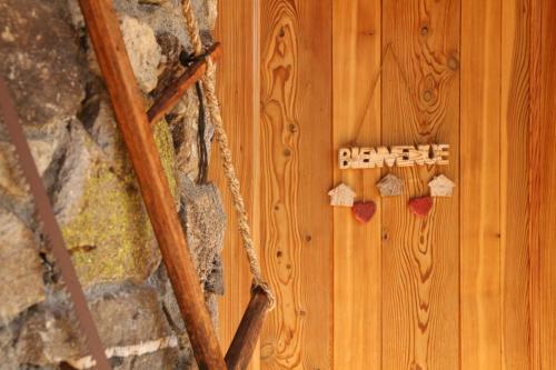 a wooden wall with a sign that says beware at Le Pied des Thûres - Family Chalet to host memorable moments! in Névache