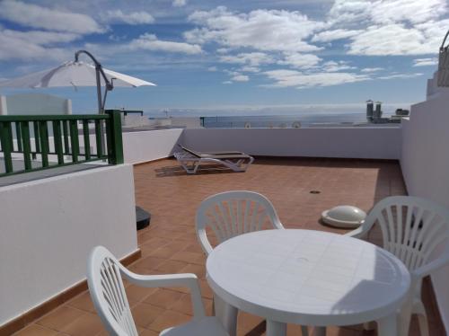 a patio area with chairs, tables and chairs at Apartamentos Casa Cipri in Playa Blanca