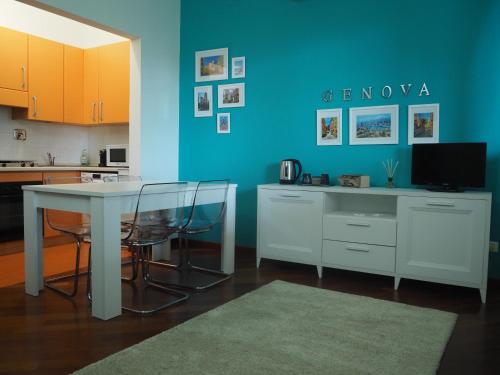une cuisine avec une table blanche et un mur bleu dans l'établissement Amba Alagi Apartment, à Gênes